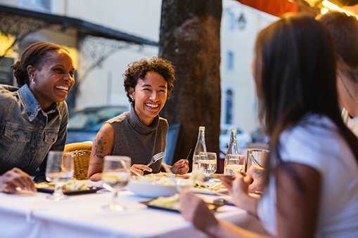 People dining outdoors at a restaurant in downtown Tacoma near the Theater District